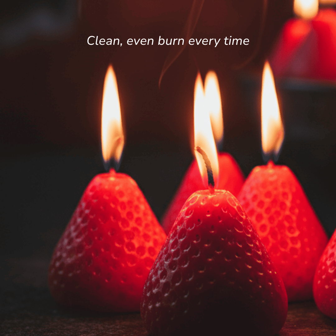 Close-up of multiple strawberry candles burning with a clean, even golden flame